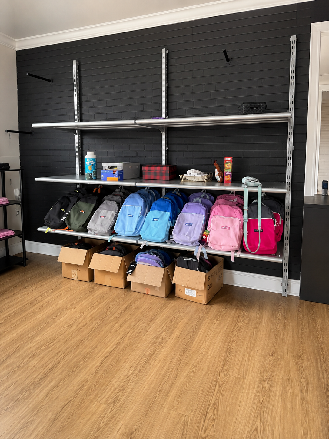 Colorful backpacks arranged on shelves