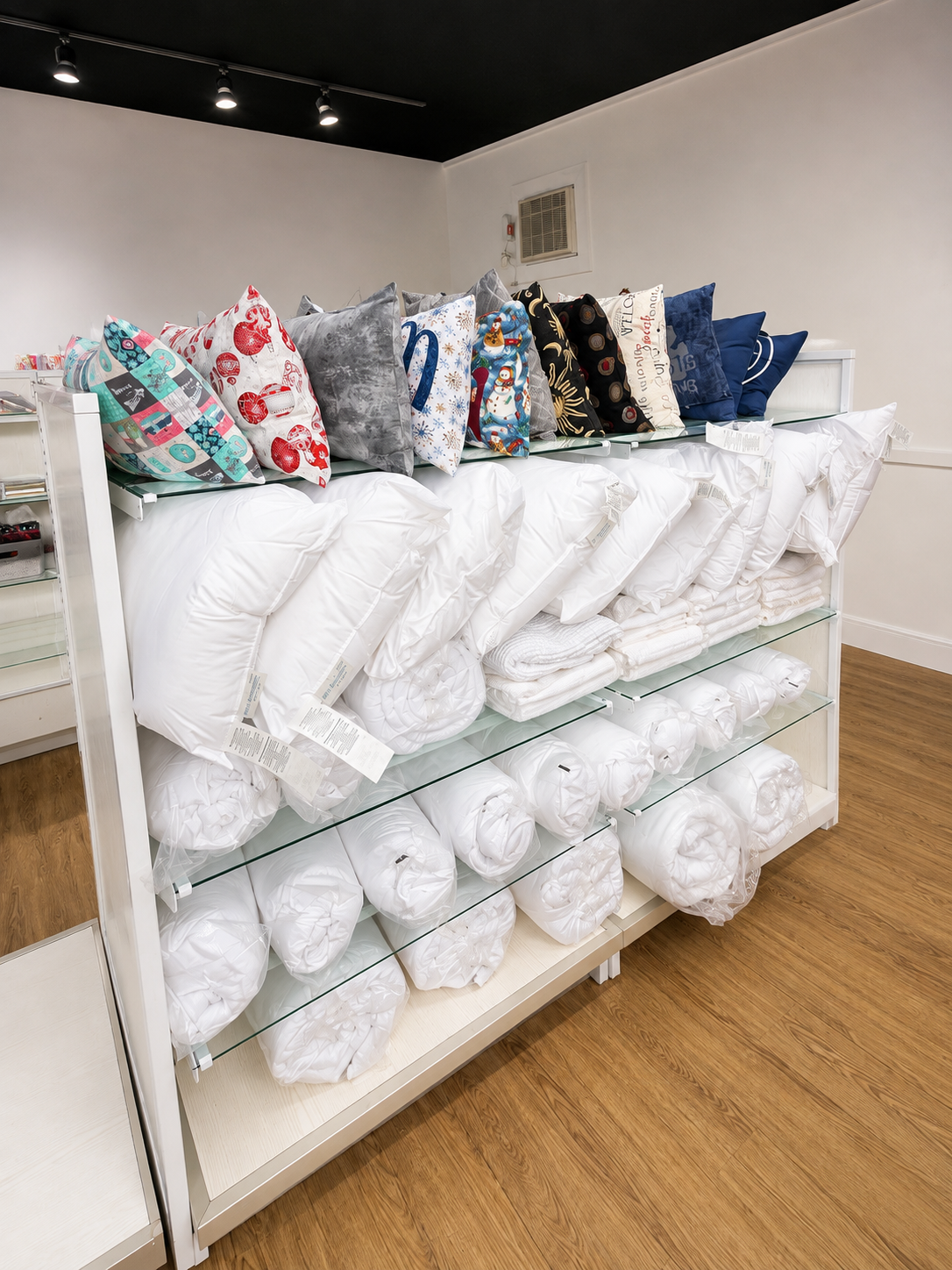Pillows, blankets, and bedding arranged on shelves